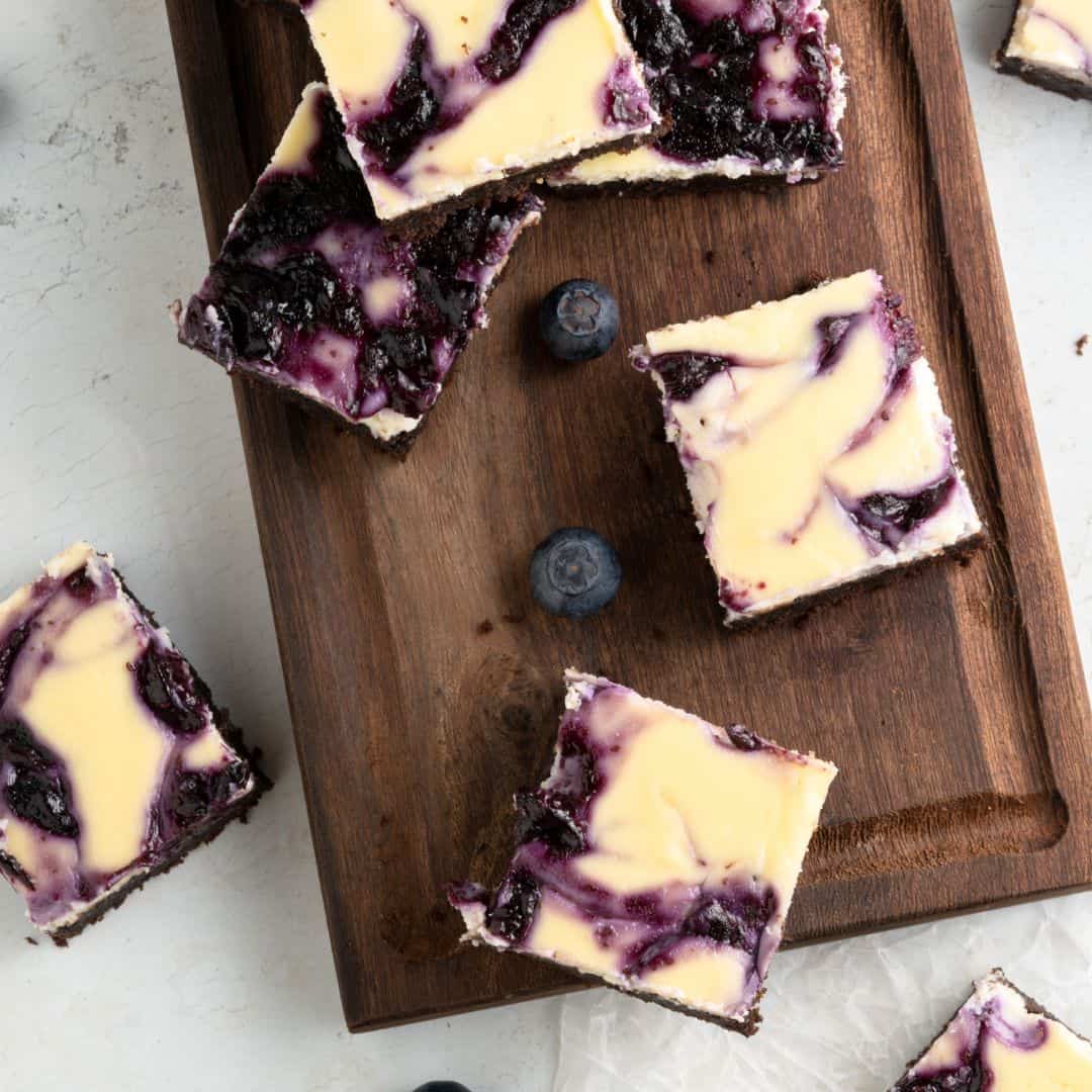 Sugar Free Cheesecake Brownies, a delicious and simple three layered no added sugar dessert featuring a blueberry swirl topping.