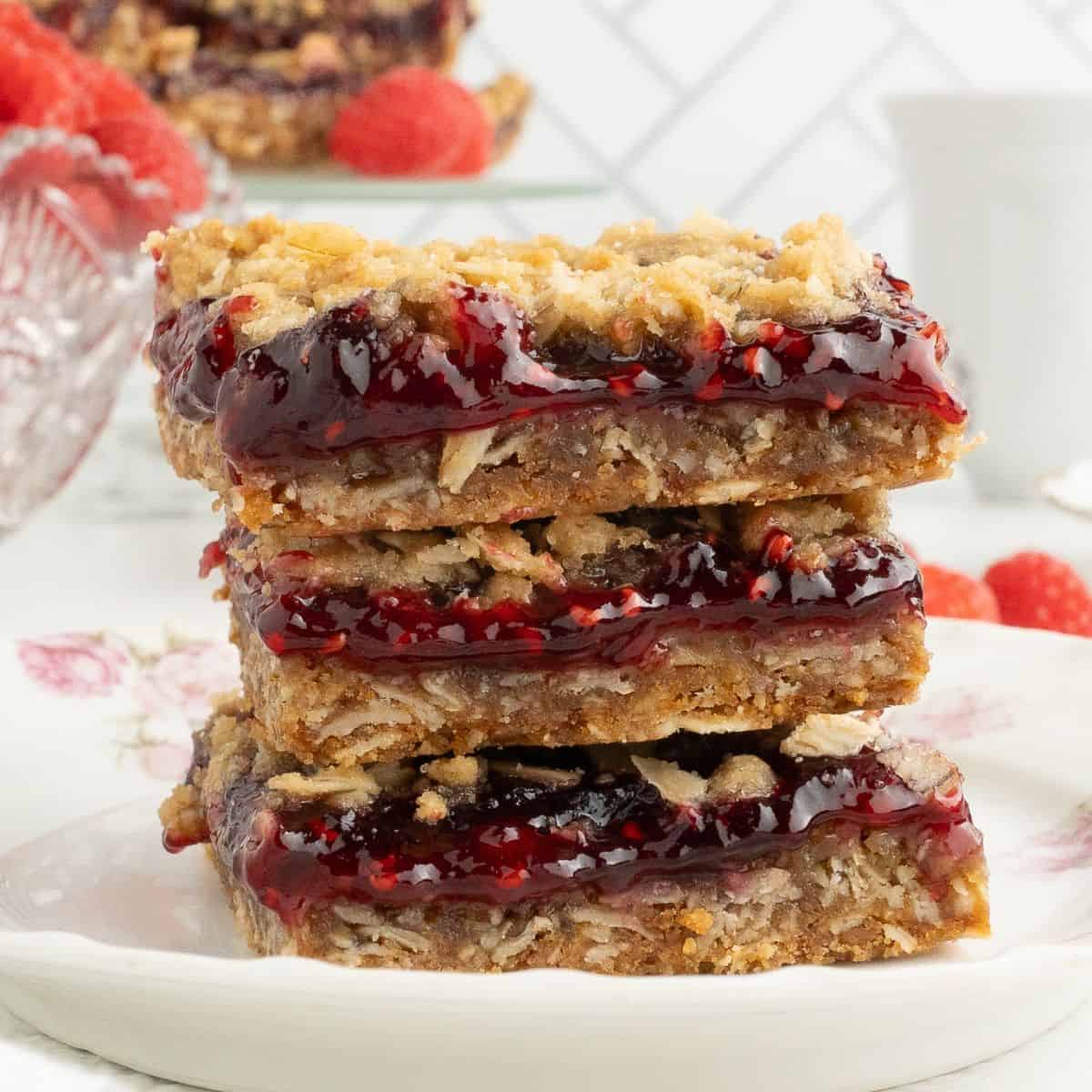 Raspberry Oatmeal Bars- A simple and delicious dessert bar recipe made with oats and raspberry preserves with no added sugar.